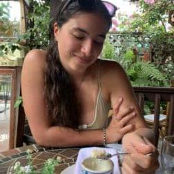 W&J rising senior Isabella Manzari smiles down at a cup of Cuban cuisine.