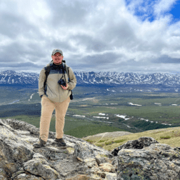 Recent W&J alumnus Jeffrey Seabury, Jr. '22 stands atop a mountain in Alaska during his Magellan Project.