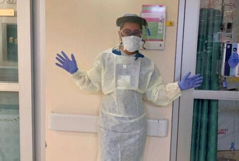 Bianca Pate '22 poses in PPE outside a room at the Latrobe Hospital ICU.