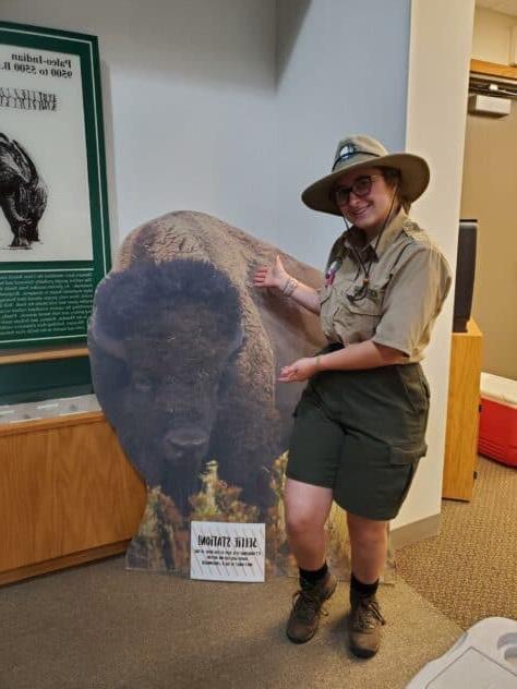 semesters studying in historic structures and cozy W&J senior Stephanie Shugerman poses with cardboard buffalo in park ranger uniform.